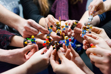 Group of Kids holding lego figures in their hands