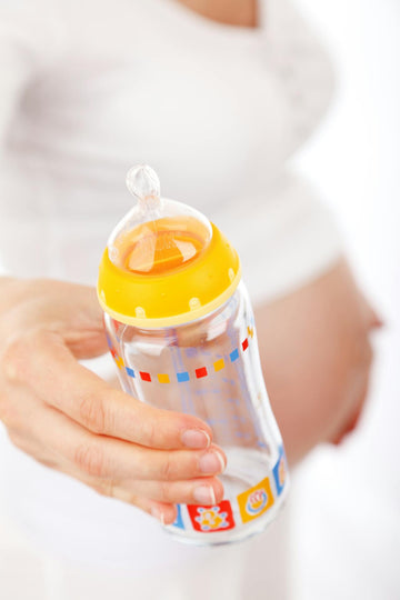 Pregnant Lady Holding Baby Bottle