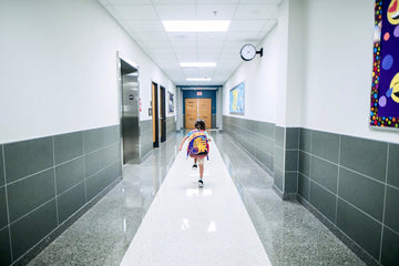 Kid running in his school hallway