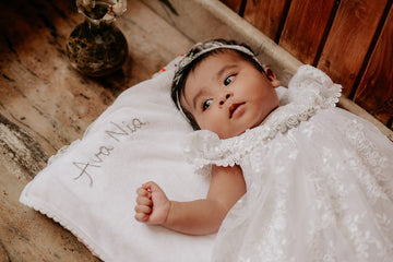 Baby on a blanket with her name written on it