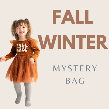 A colorful mystery box with cozy, patterned children's fall and winter clothing.