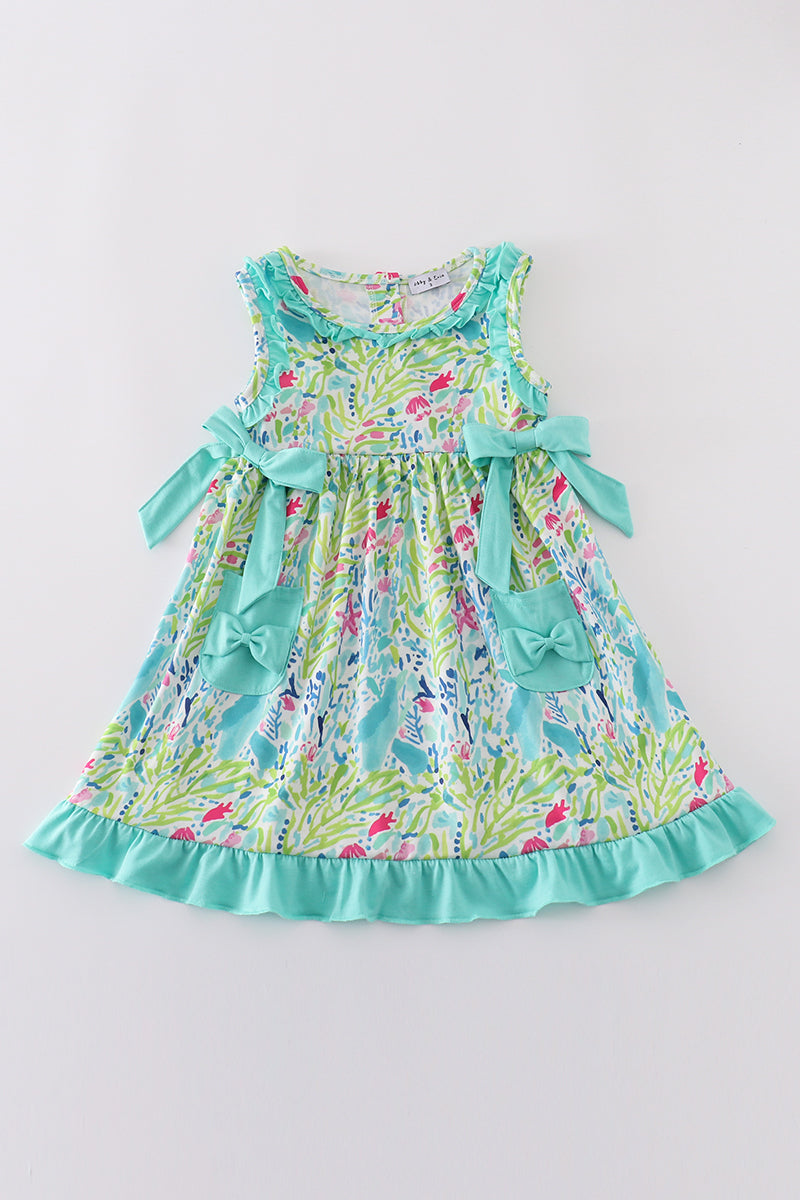 Tropical breeze print dress with vibrant palm leaves, perfect for sunny adventures.