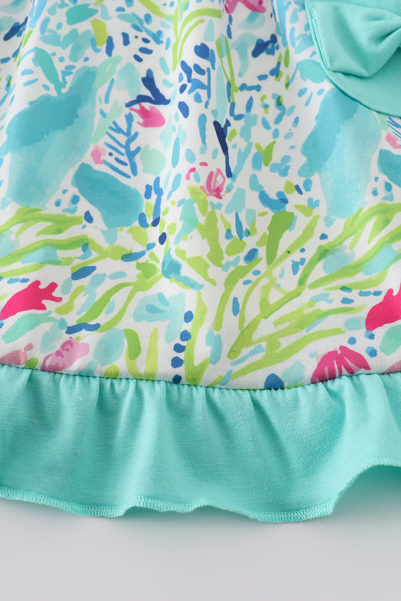 Tropical breeze print dress with vibrant palm leaves, perfect for sunny adventures.