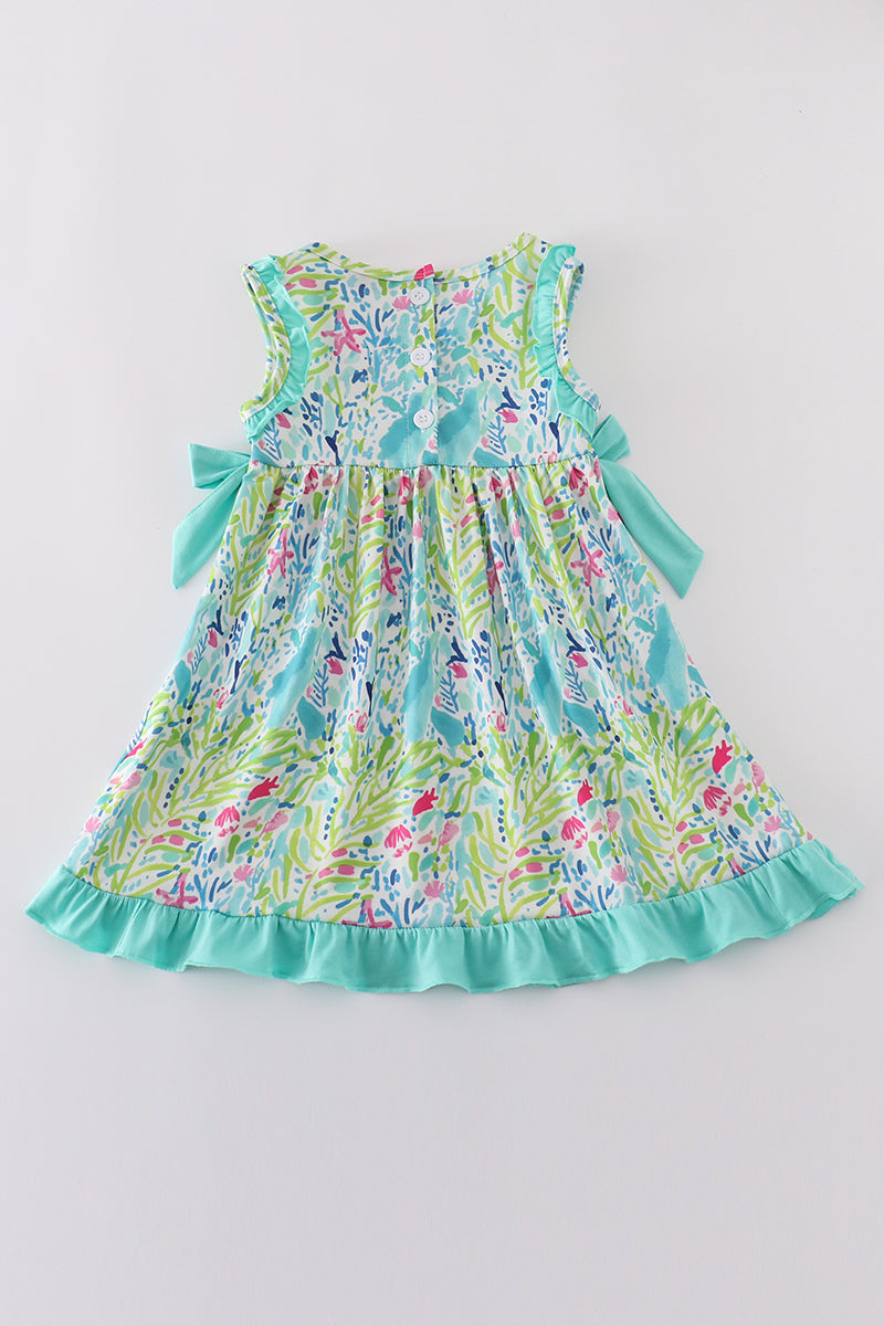 Tropical breeze print dress with vibrant palm leaves, perfect for sunny adventures.