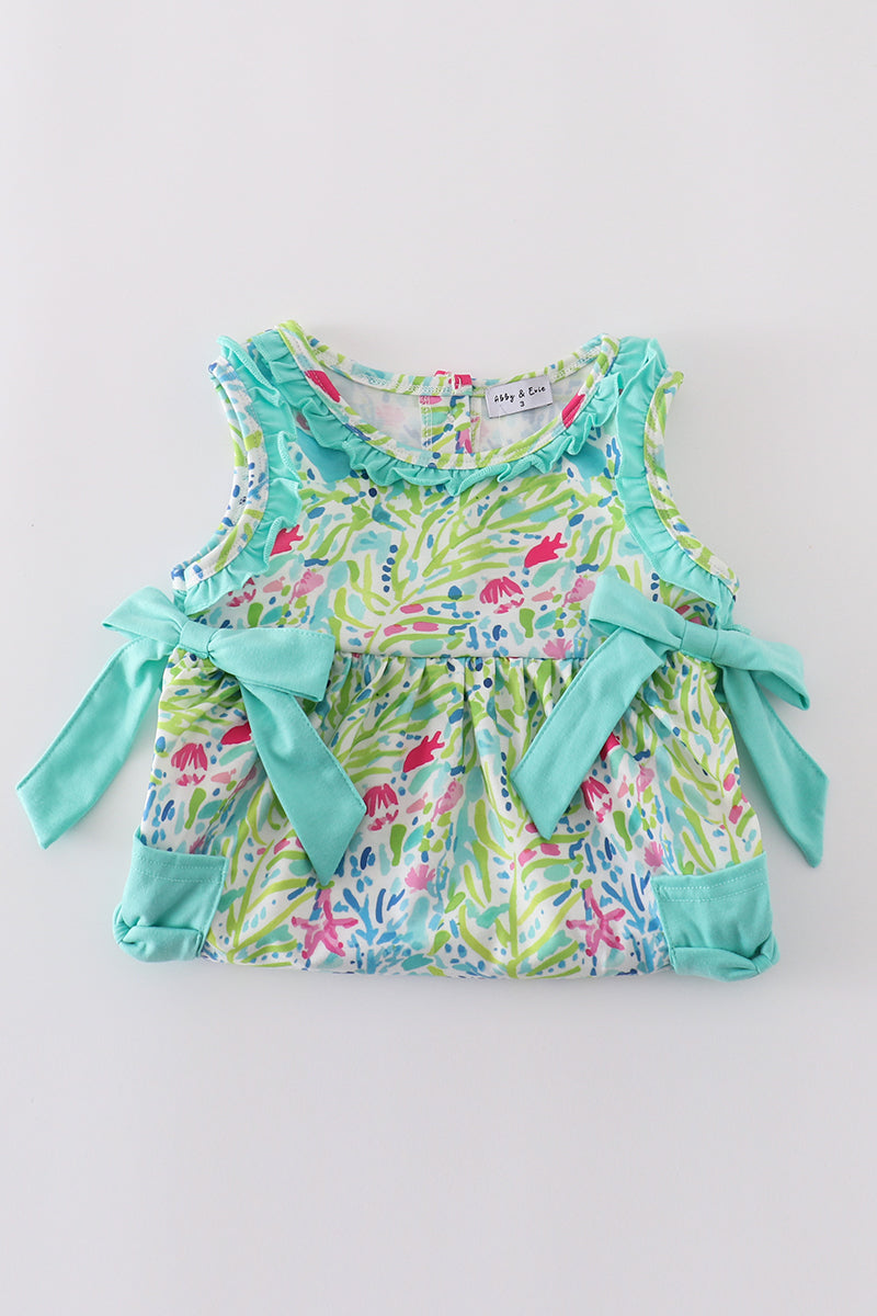 Tropical breeze print dress with vibrant palm leaves, perfect for sunny adventures.