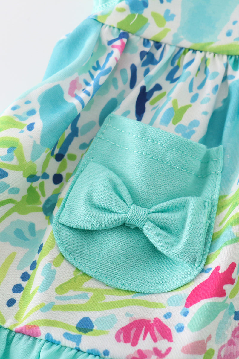 Tropical breeze print dress with vibrant palm leaves, perfect for sunny adventures.