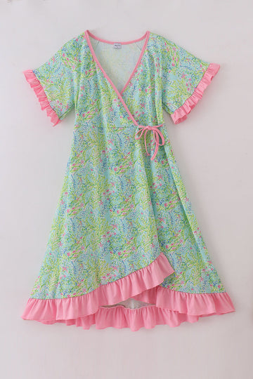 A charming adult ruffle dress with a whimsical meadow breeze floral print.
