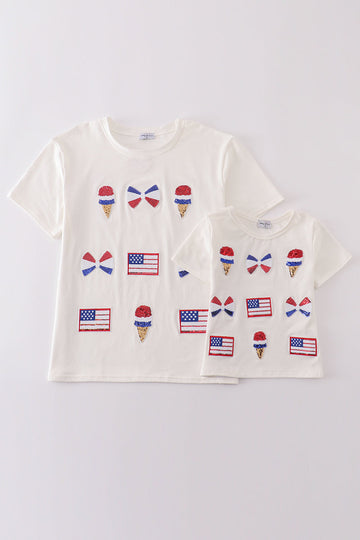 Children's top with flag bow, ice-cream, and sequin details, perfect for matching outfits.