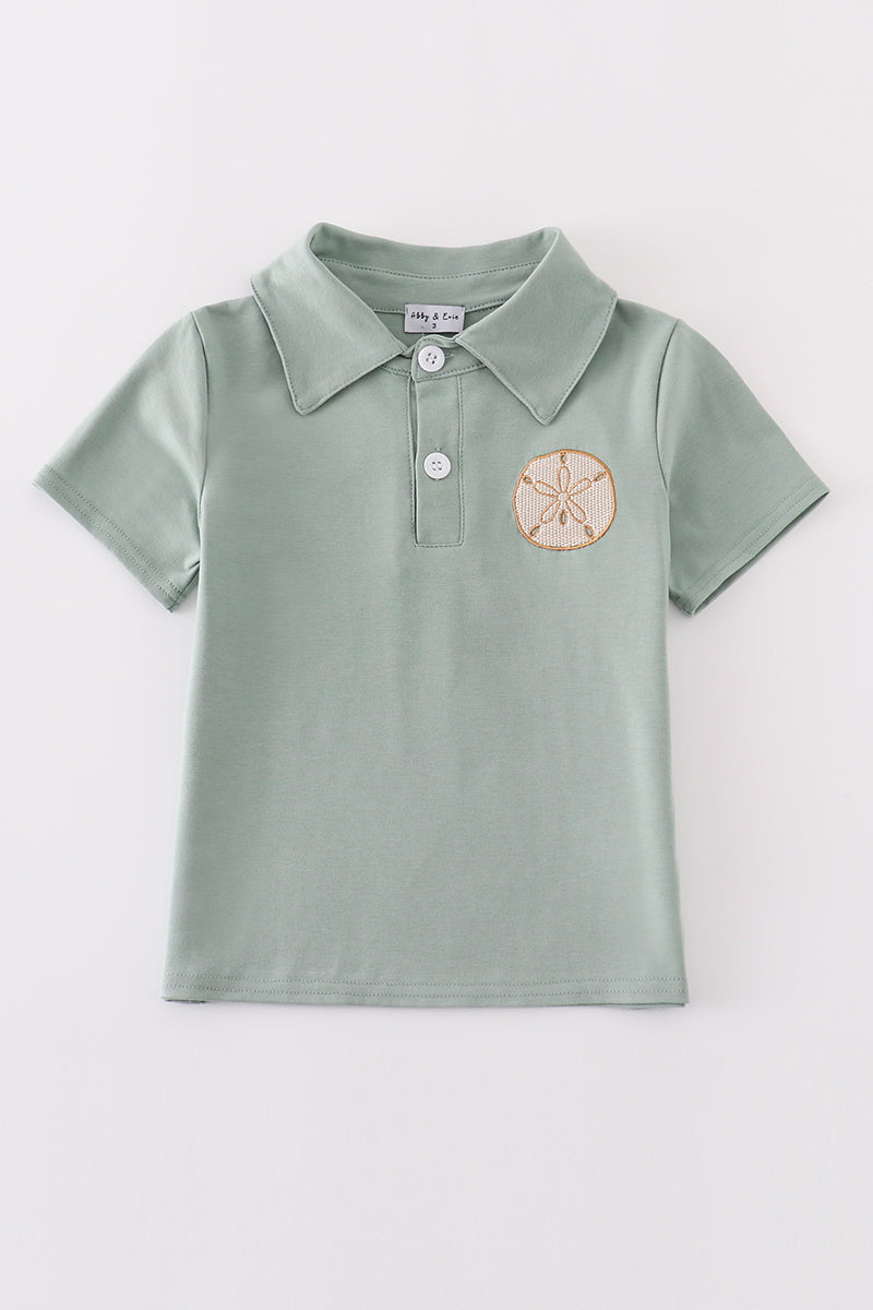 Sage green boy's shirt with delicate sand dollar embroidery, perfect for beach outings.