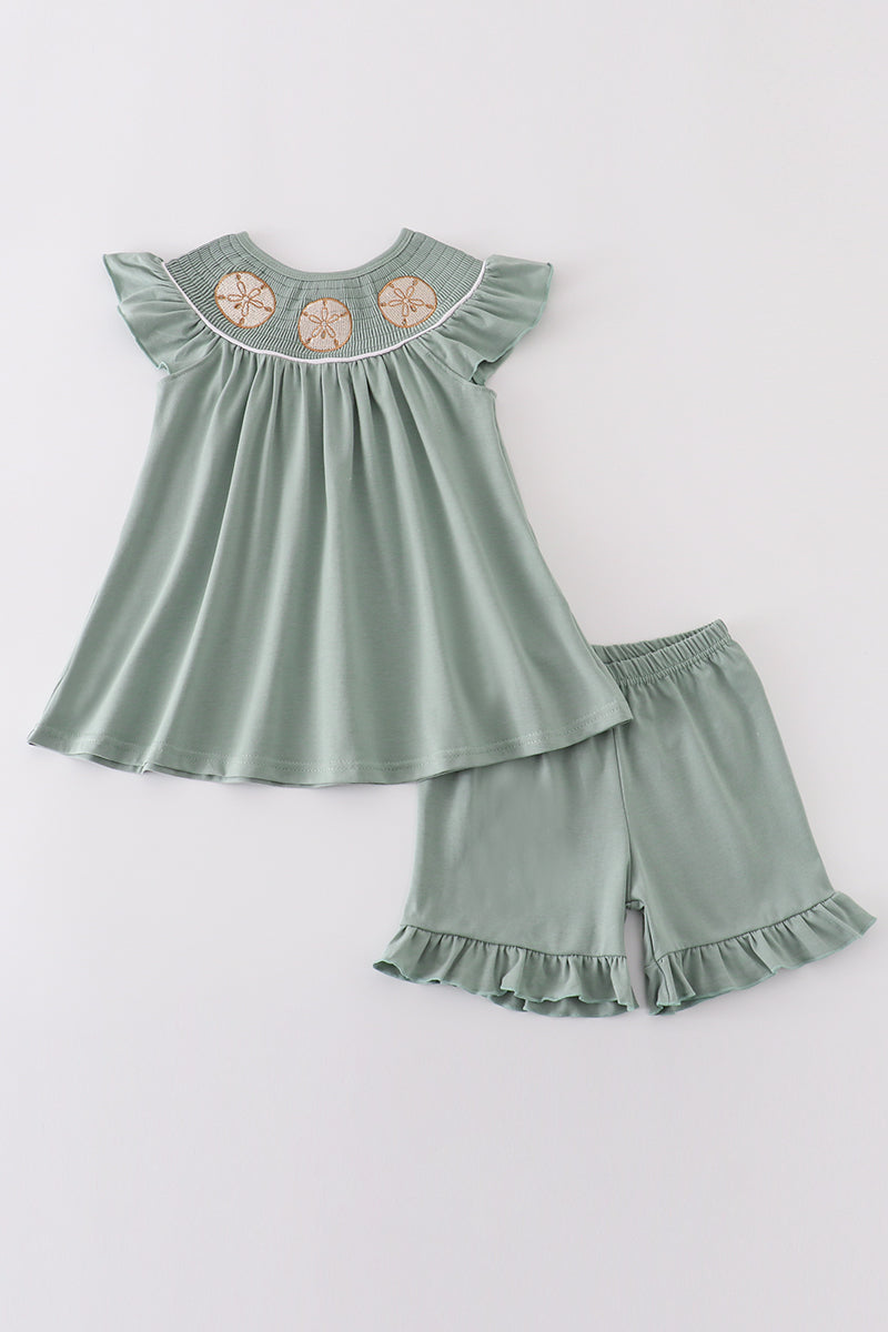 Sage smocked girl set with sand dollar embroidery, perfect for summer outings.