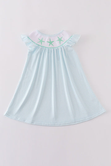 A charming blue stripe dress with starfish embroidery and smocked detailing, perfect for summer.