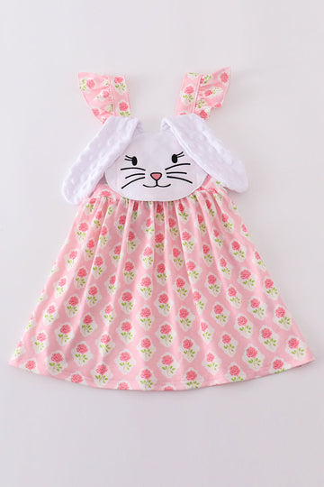 A charming pink dress with a floral bunny applique, perfect for springtime play.