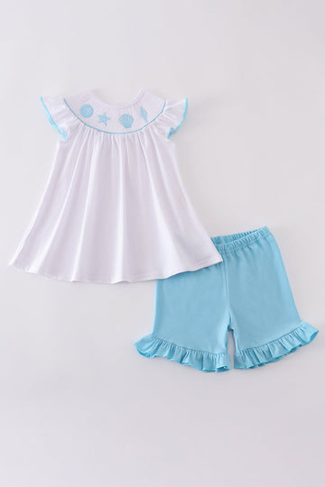 White smocked set with starfish embroidery, perfect for beach outings.