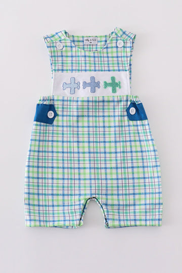 Blue plaid jonjon with charming airplane embroidery, perfect for playful adventures.