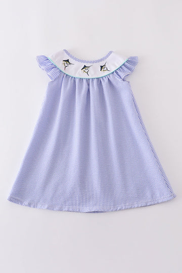 Blue stripe seersucker dress with charming swordfish embroidery, perfect for summer adventures.