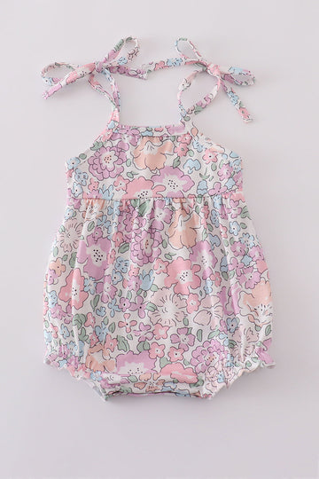 Pink blush bubble romper with a garden bloom print, perfect for spring outings.