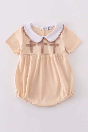Cream bubble romper with delicate cross French knot embroidery, perfect for special occasions.
