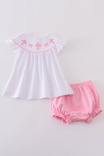 Pink smocked bloomer set with cross embroidery, perfect for special occasions.