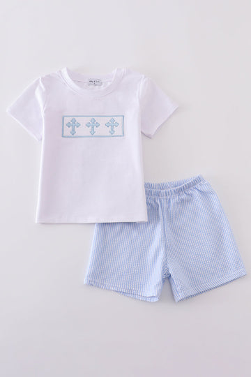 A charming blue smocked set with cross embroidery, perfect for special occasions.
