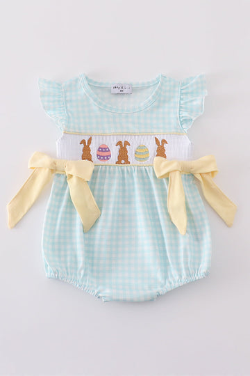 A blue smocked bubble with adorable bunny embroidery, perfect for spring outings.