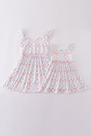 Matching blue lattice print dresses with bows, perfect for mom and daughter outings.