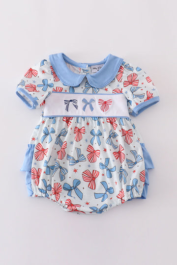 Adorable ruffle bubble with bow trellis print and delicate embroidery.