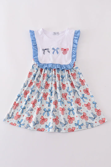 A sweet ruffle dress with bow trellis print and delicate embroidery, perfect for playdates.
