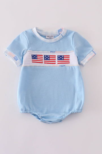 A charming blue bubble romper with delicate flag embroidery, perfect for summer fun.