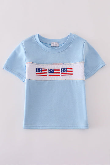 Blue flag embroidery top for kids, featuring playful flag patterns on soft fabric.