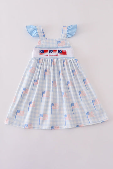 Blue gingham dress with smocked embroidery, perfect for summer outings.