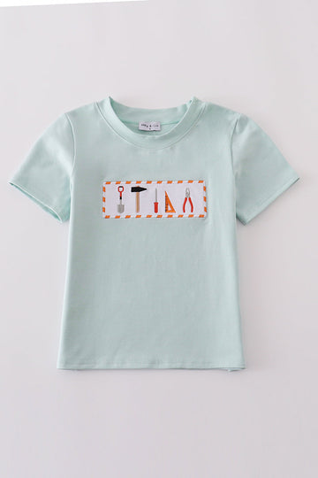 Blue embroidered top for kids with playful tool patterns, perfect for casual outings.