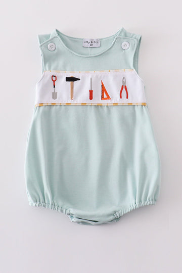 Adorable blue bubble romper with delicate tool embroidery, perfect for special occasions.