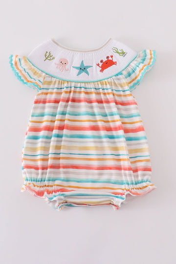 Colorful smocked bubble with rainbow stripes and marine creature embroidery.