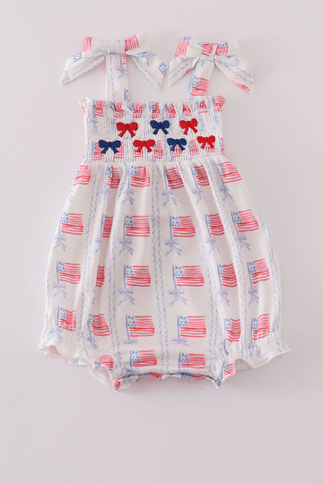 Adorable smocked bubble with bow embroidery, perfect for special occasions.