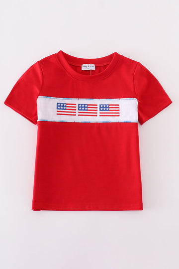 Children's smocked top with colorful flag embroidery, perfect for patriotic celebrations.