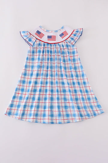 A charming smocked dress with colorful flag embroidery, perfect for festive occasions.
