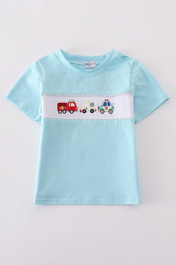 Blue smocked top with fire truck and police car embroidery for kids.