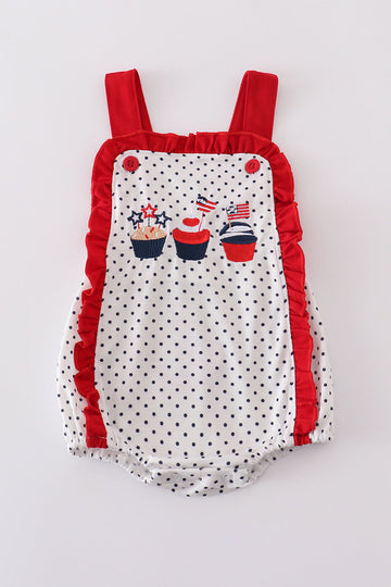 Adorable red ruffle bubble with cake embroidery and playful polka dots.