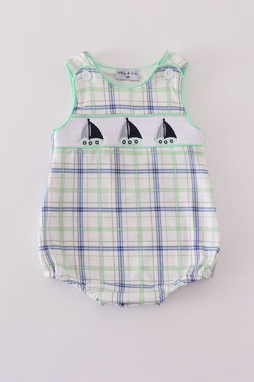 A charming green seersucker bubble with sailboat embroidery, perfect for summer fun.