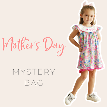 A cheerful Mother's Day Mystery Box filled with colorful children's clothing.