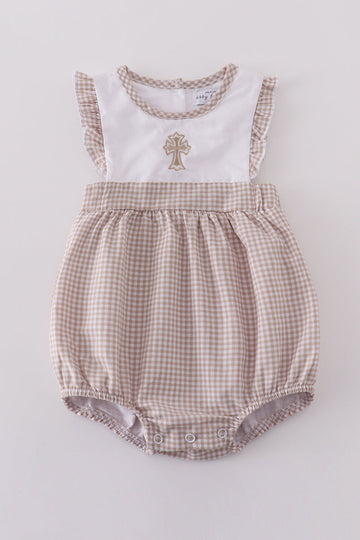 A cozy, pastel-colored bubble romper with delicate cross embroidery for toddlers.
