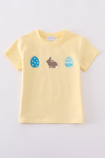 Warm mustard-colored children's top featuring a cute bunny and egg embroidery.