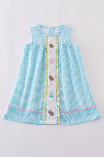 A charming mint gingham dress with bunny and egg embroidery, perfect for Easter.