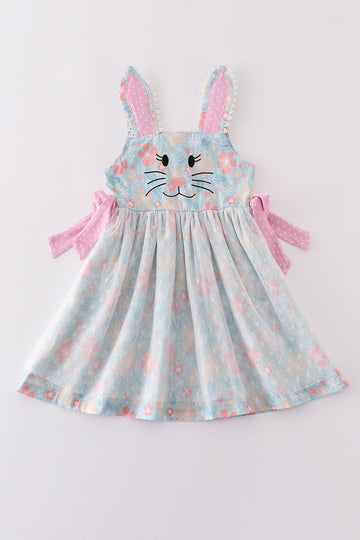 A charming green floral dress with bunny bow, perfect for springtime adventures.