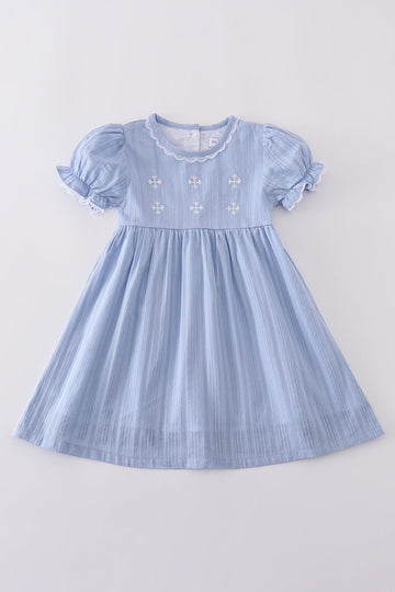 A charming blue dress with delicate cross embroidery, perfect for special occasions.
