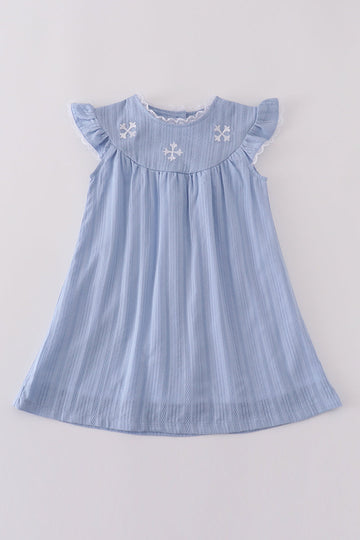 A charming blue dress with cross embroidery, perfect for special occasions.