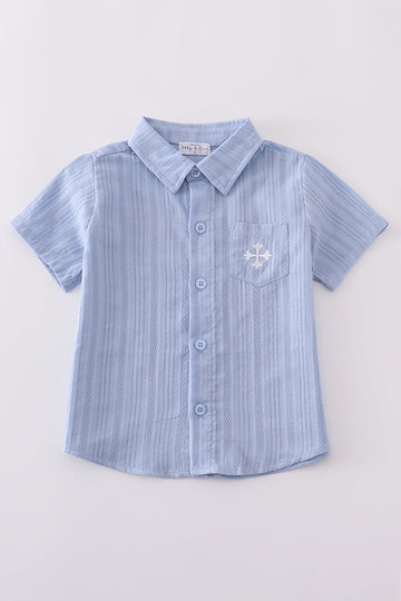A charming blue button-down shirt with cross embroidery, perfect for kids.