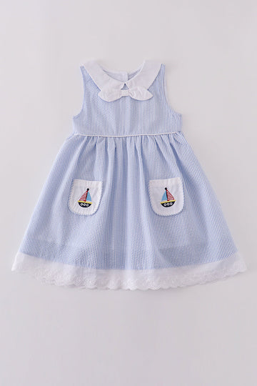Premium blue dress with sailboat embroidery, perfect for a sunny day adventure.