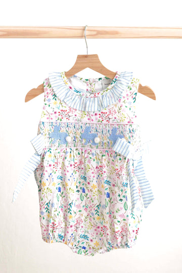 Floral Easter bunny hand-smocked girl bubble with pastel colors and ruffled sleeves.
