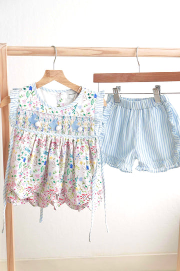 Floral Easter bunny hand-smocked girl's set with pastel colors and ruffled sleeves.